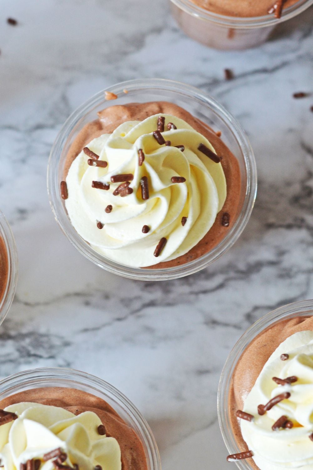 overhead look of Rumchata Pudding Shots on a marble table 