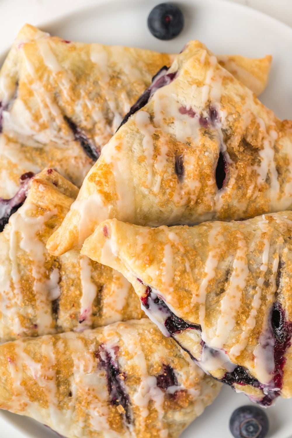 Blueberry Turnovers stacked on a plate
