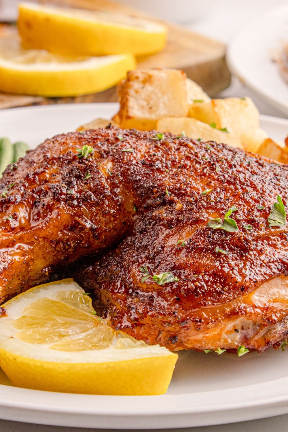 Smoked Whole Chicken leg on table with lemon wedge