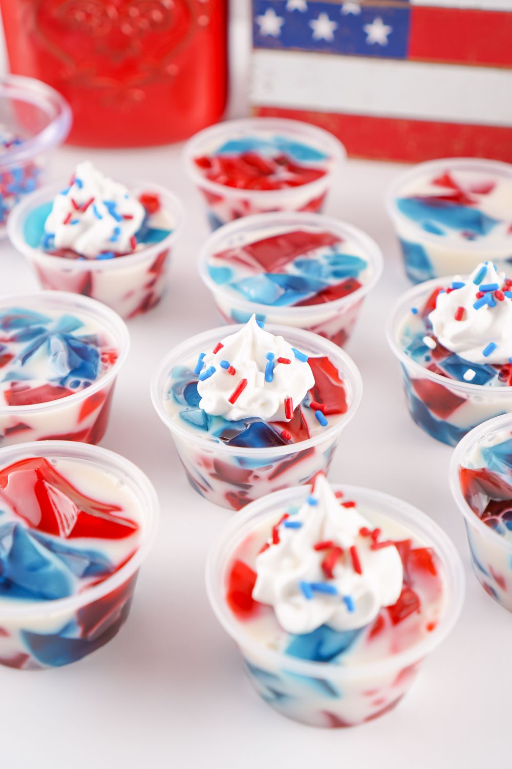 Red White and Blue Jello Shots scattered in containers on table