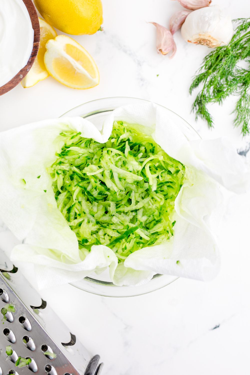 shredded cucumbers in a cheesecloth on table