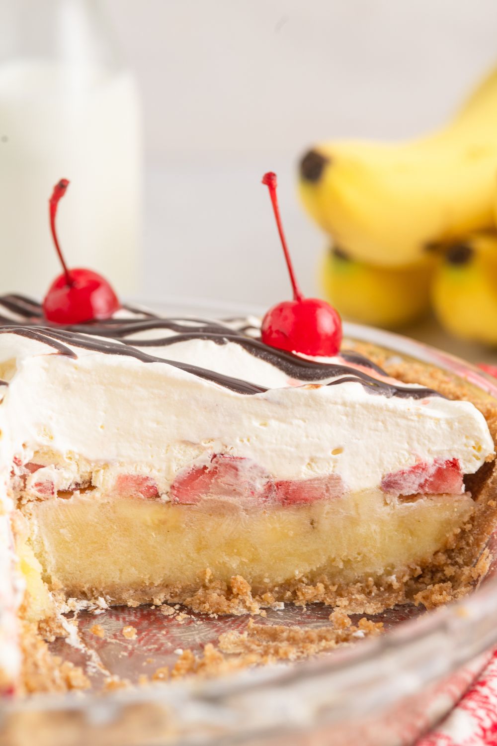 No Bake Banana Split Pie with a piece taken out of it, to show layers in the pie