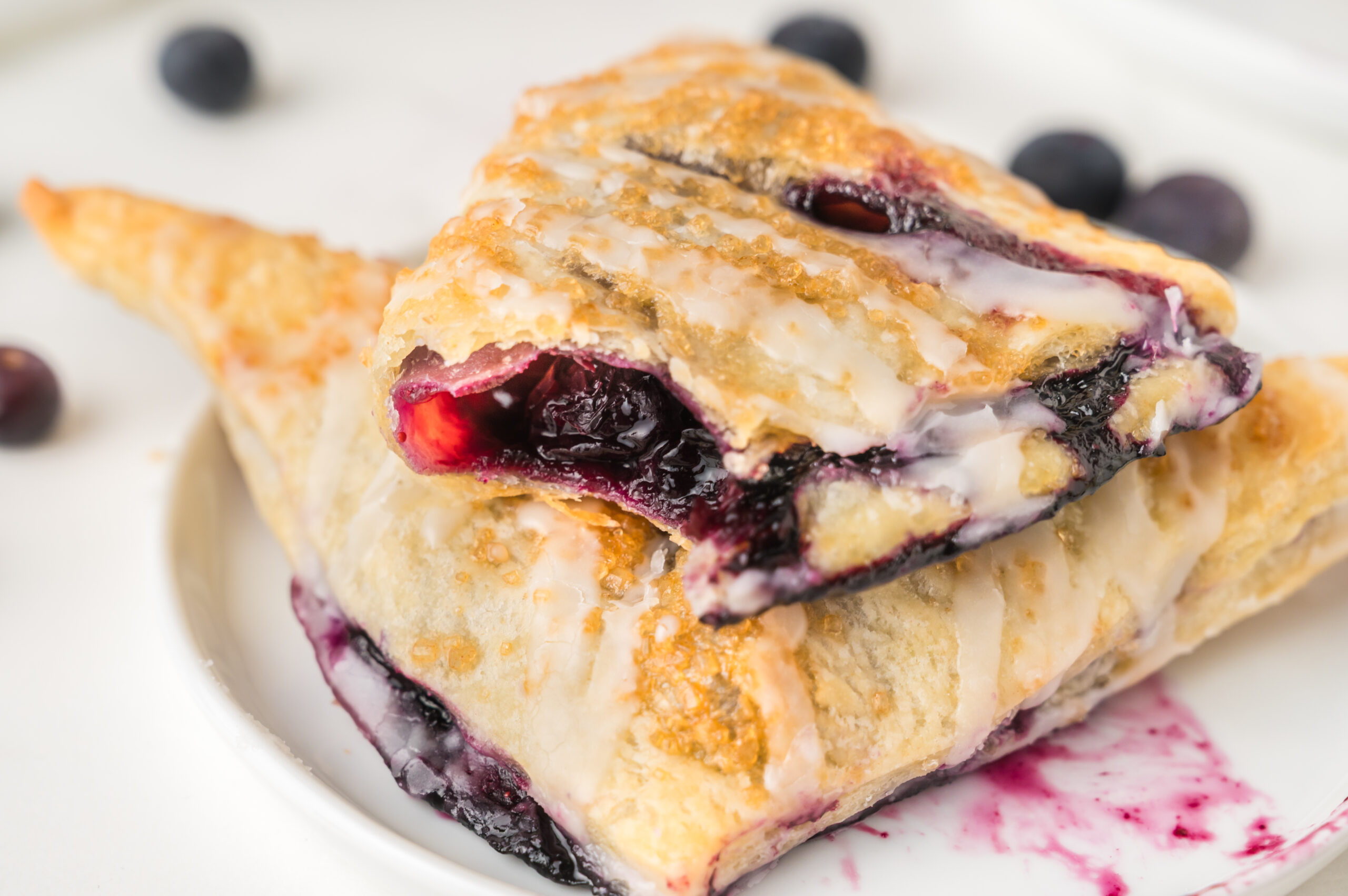 up close shot of the Blueberry Turnovers on plate with a bite missing