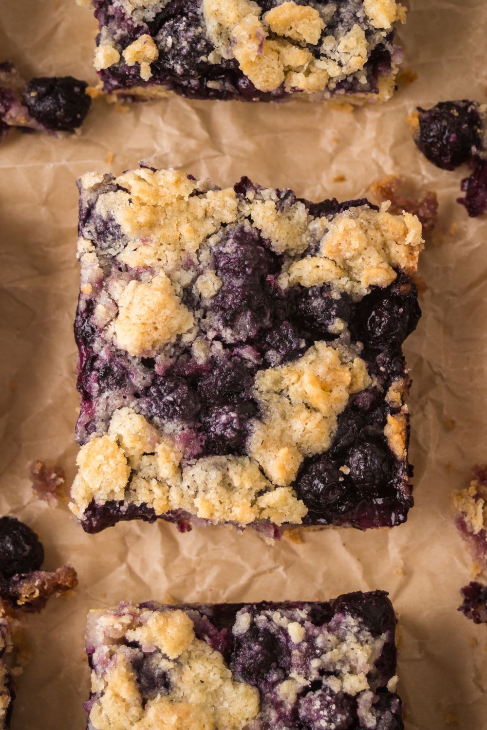 sliced Blueberry Crumb Bars on parchment paper