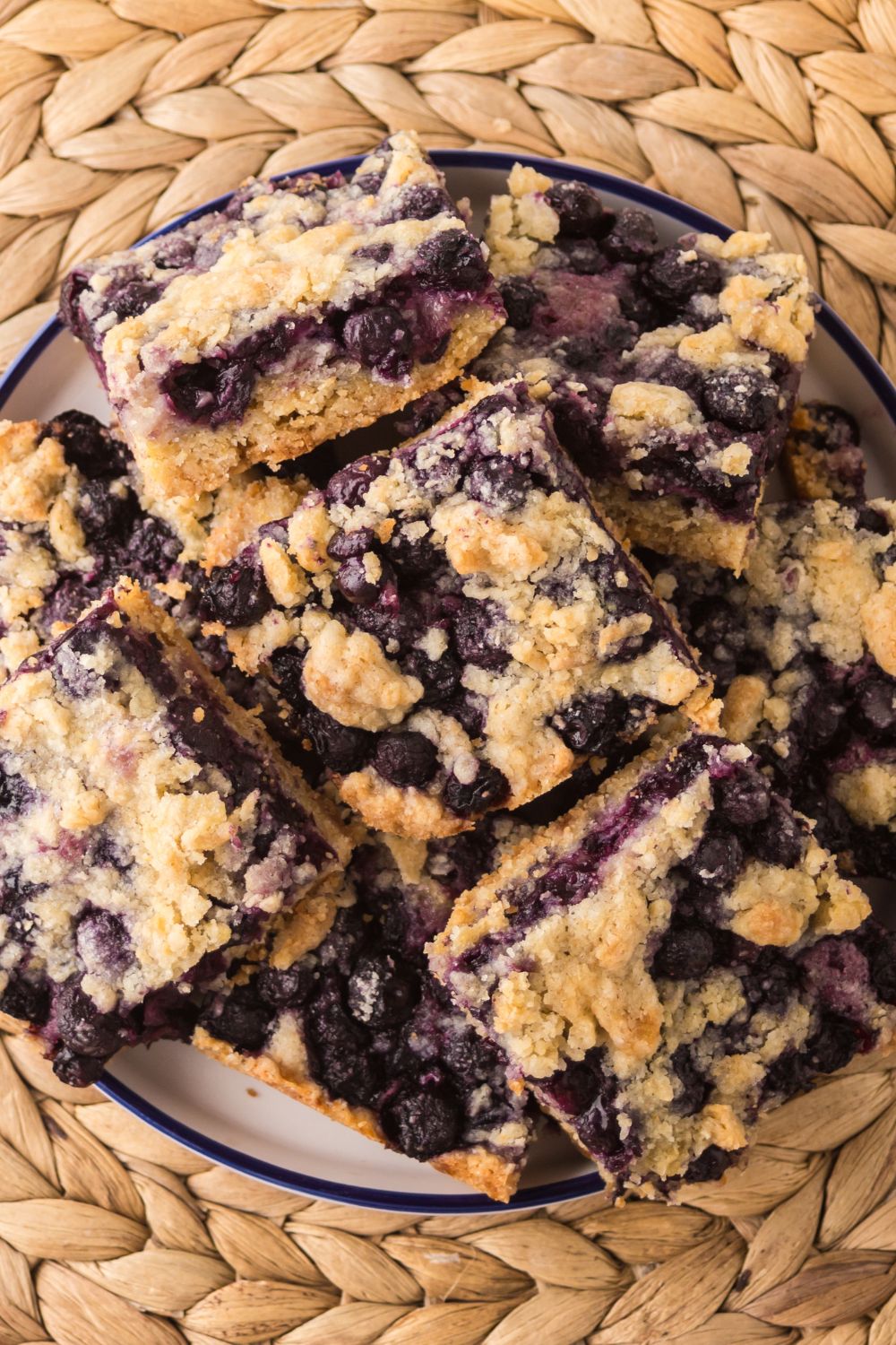 Blueberry Crumb Bars on a plate stacked on top of one another