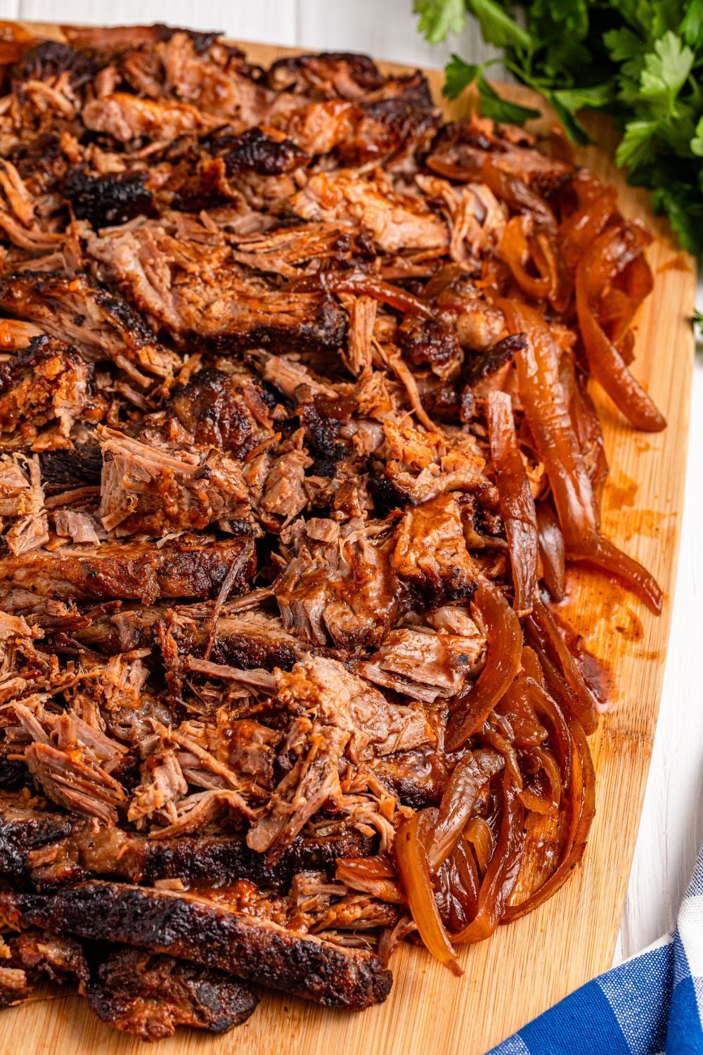 Slow Cooker BBQ Brisket shredded and on a cutting board 