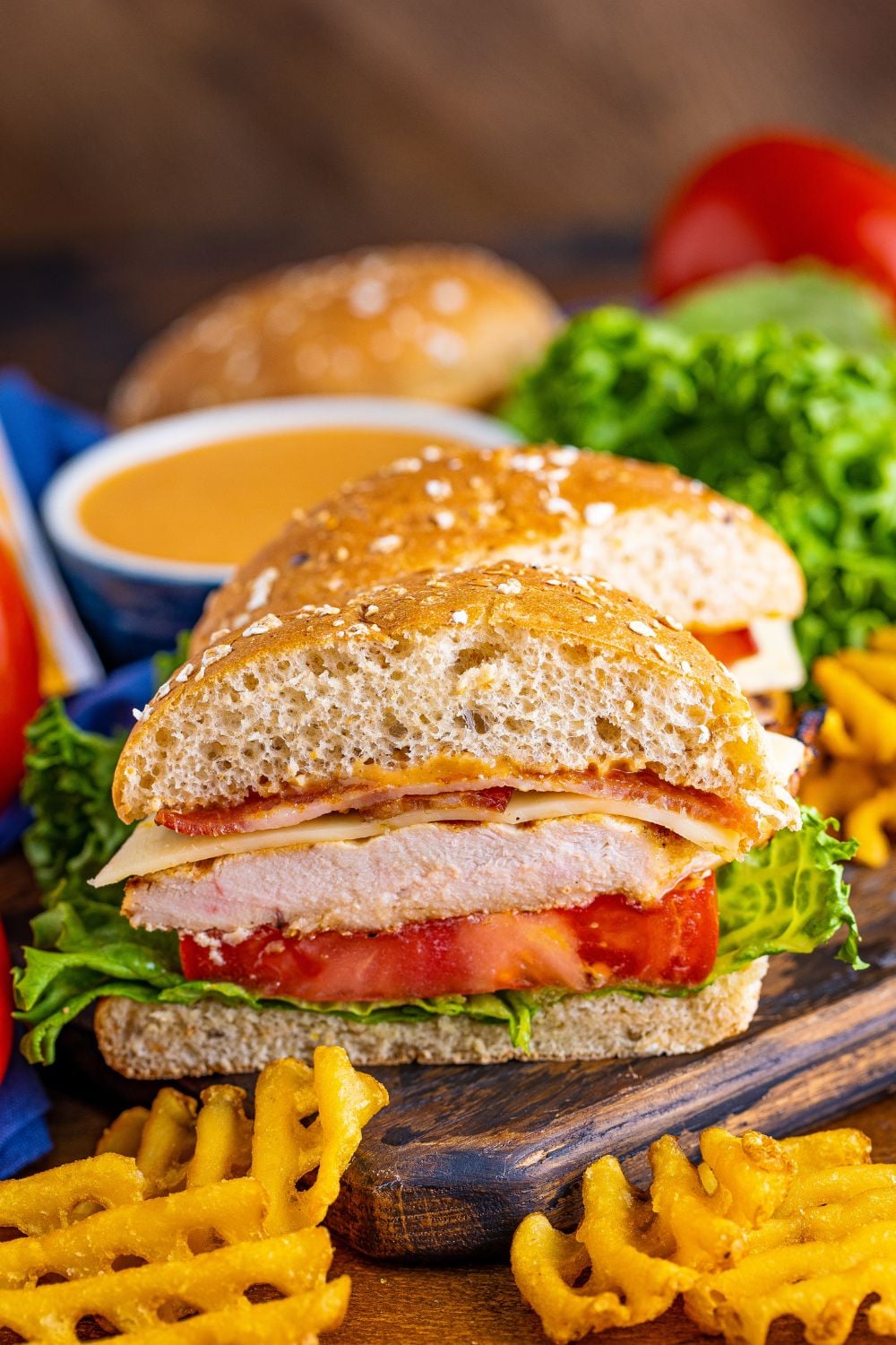 Chick Fil A Grilled Chicken Sandwich on cutting board that is sliced in half to show the layers of each ingredient 