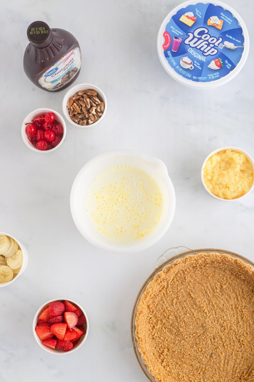 No Bake Banana Split Pie ingredients on table in single serve container