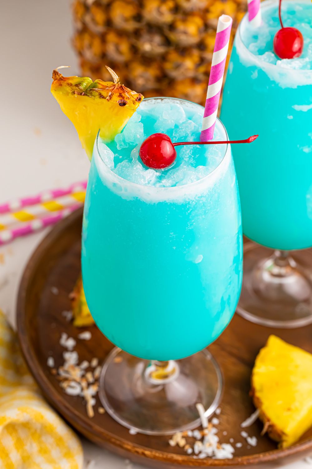 Frozen Blue Hawaiian Cocktails with a rimmed glass of sugar 