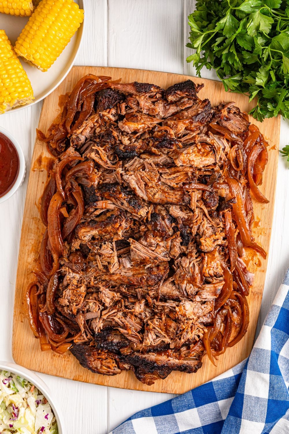 Slow Cooker BBQ Brisket shredded and placed on a cutting board on table 