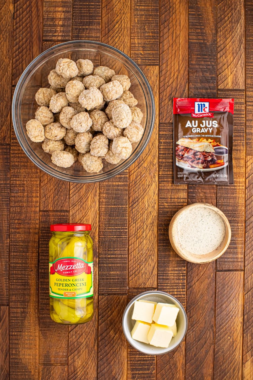 ingredients to make Crockpot Mississippi Meatballs sitting on table in single serve containers
