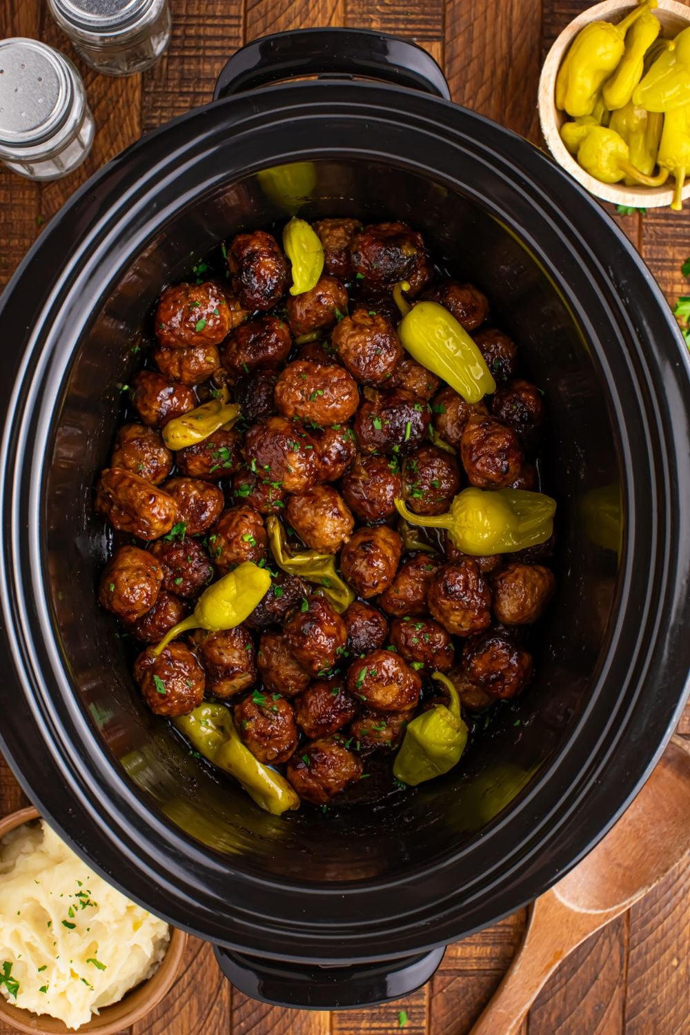 overhead look of Crockpot Mississippi Meatballs with peppers on top of the meatballs