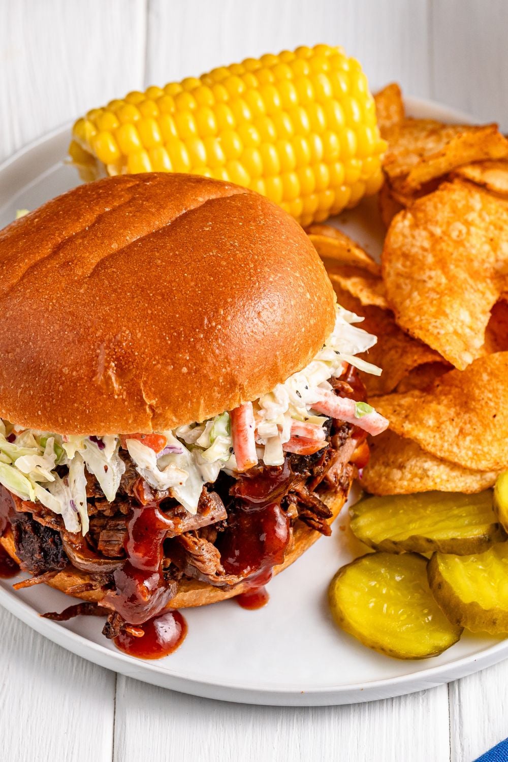 overhead look of plate with a brisket sandwich and sides 