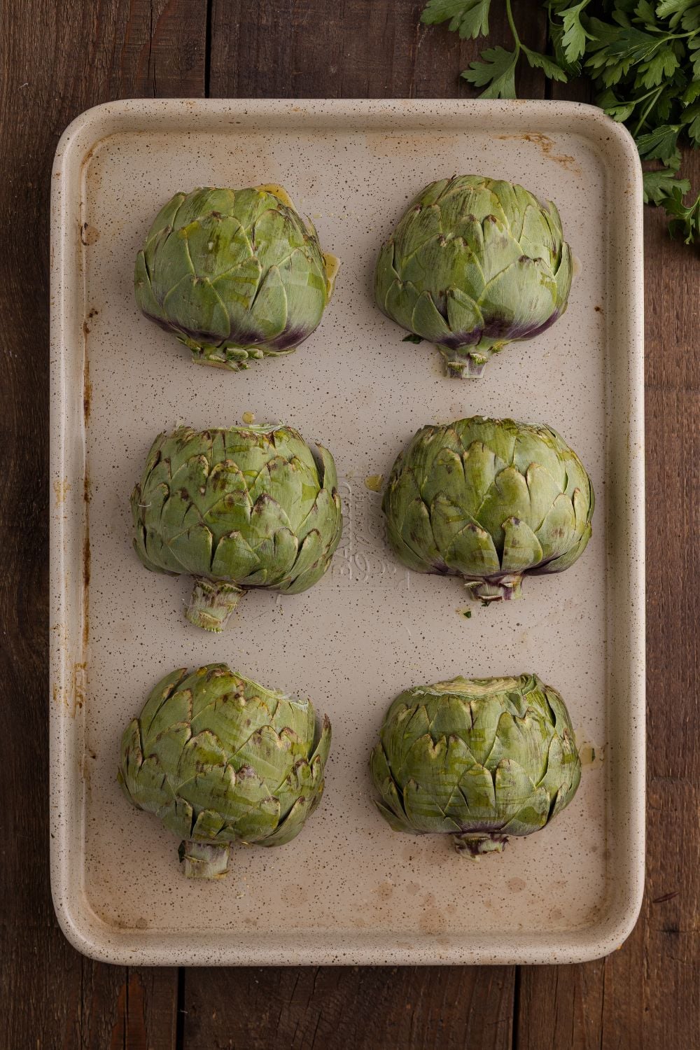 view of artichokes on baking tray on table