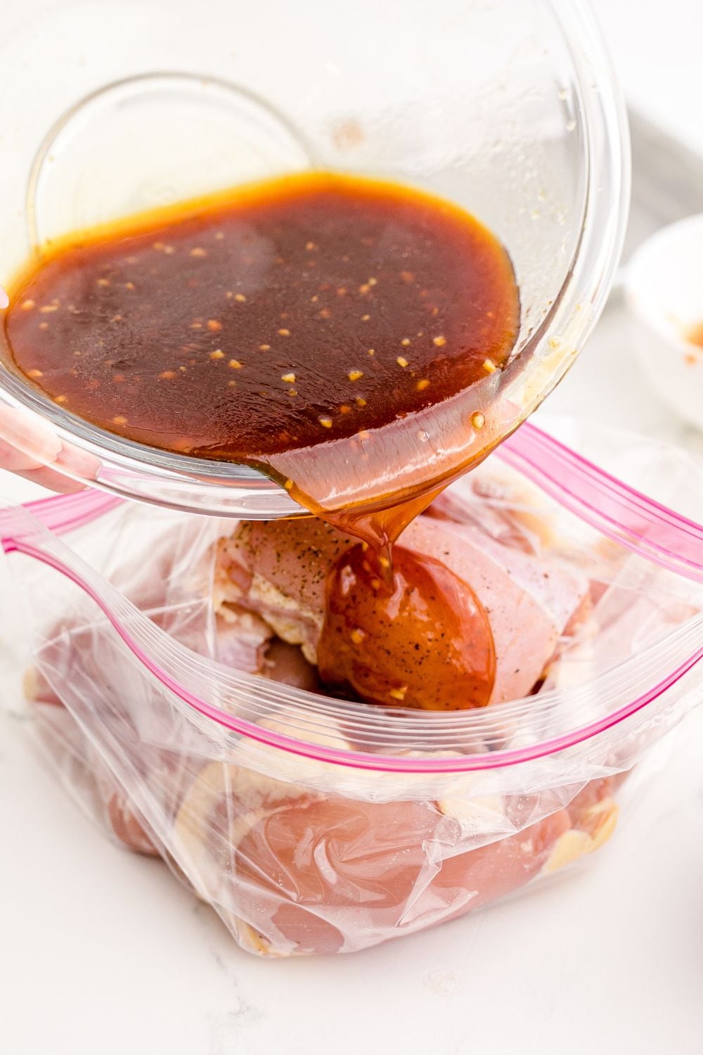 Huli Huli Chicken marinade pouring into a bag of chicken