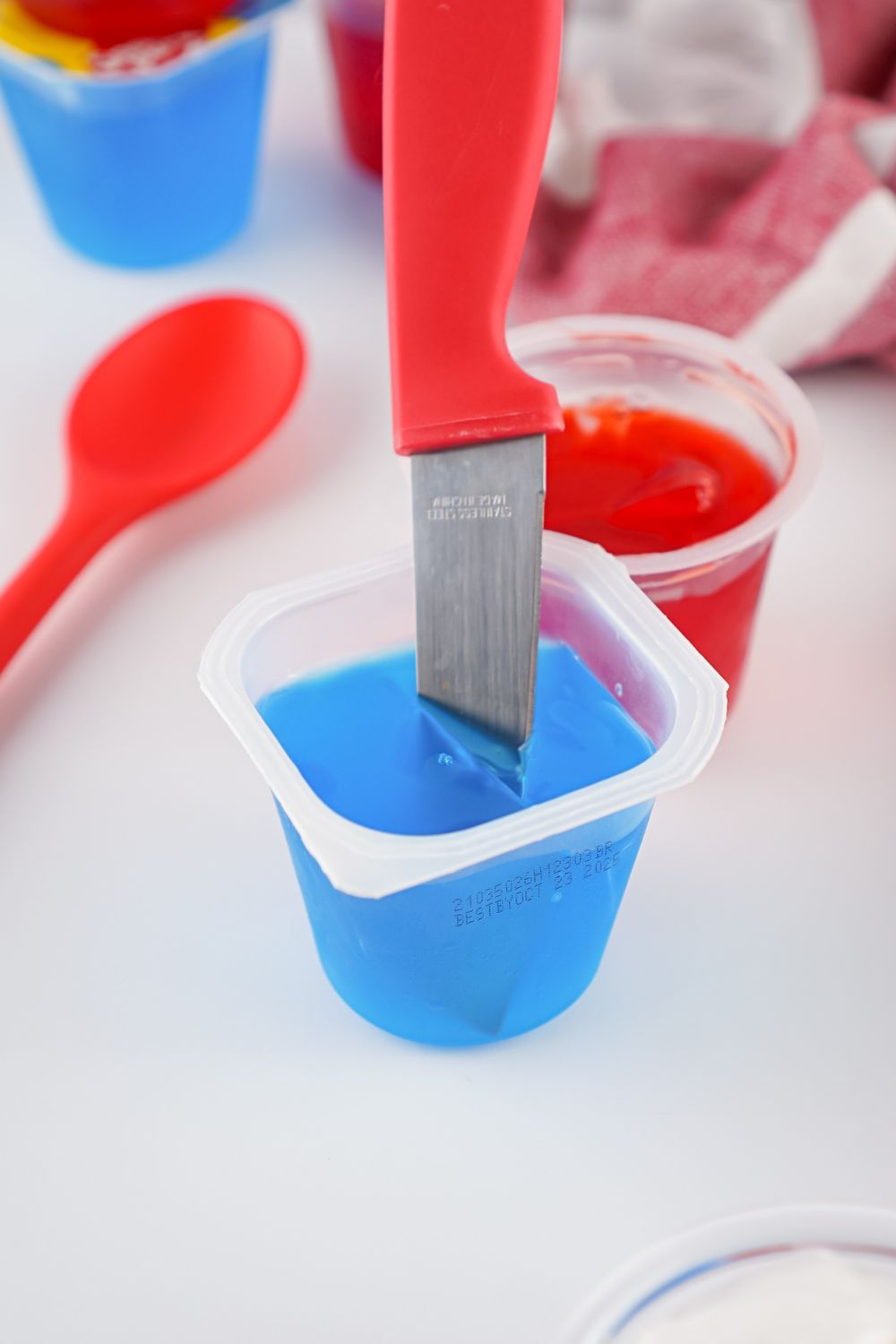 knife in jello cup cutting into cubes