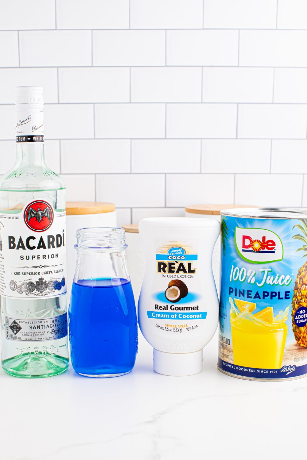 ingredients for Frozen Blue Hawaiian Cocktail on table