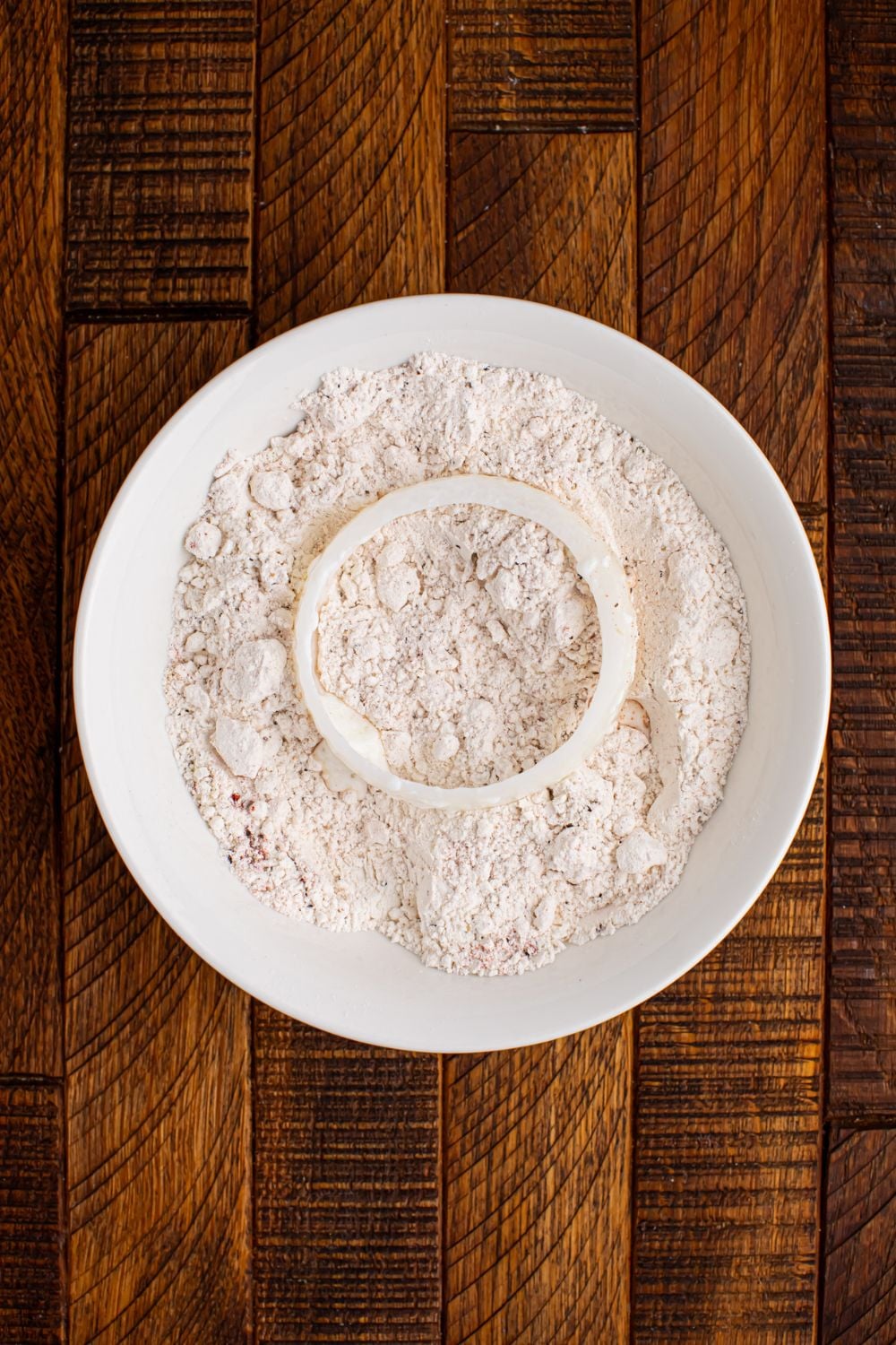 flour mixture in a bowl with onion on top of flour
