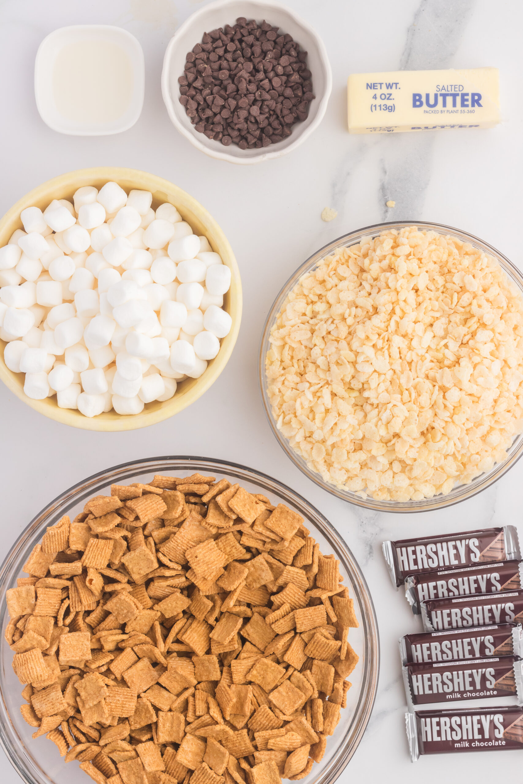 S'more Rice Krispie Treat ingredients laid out on a white marble table 