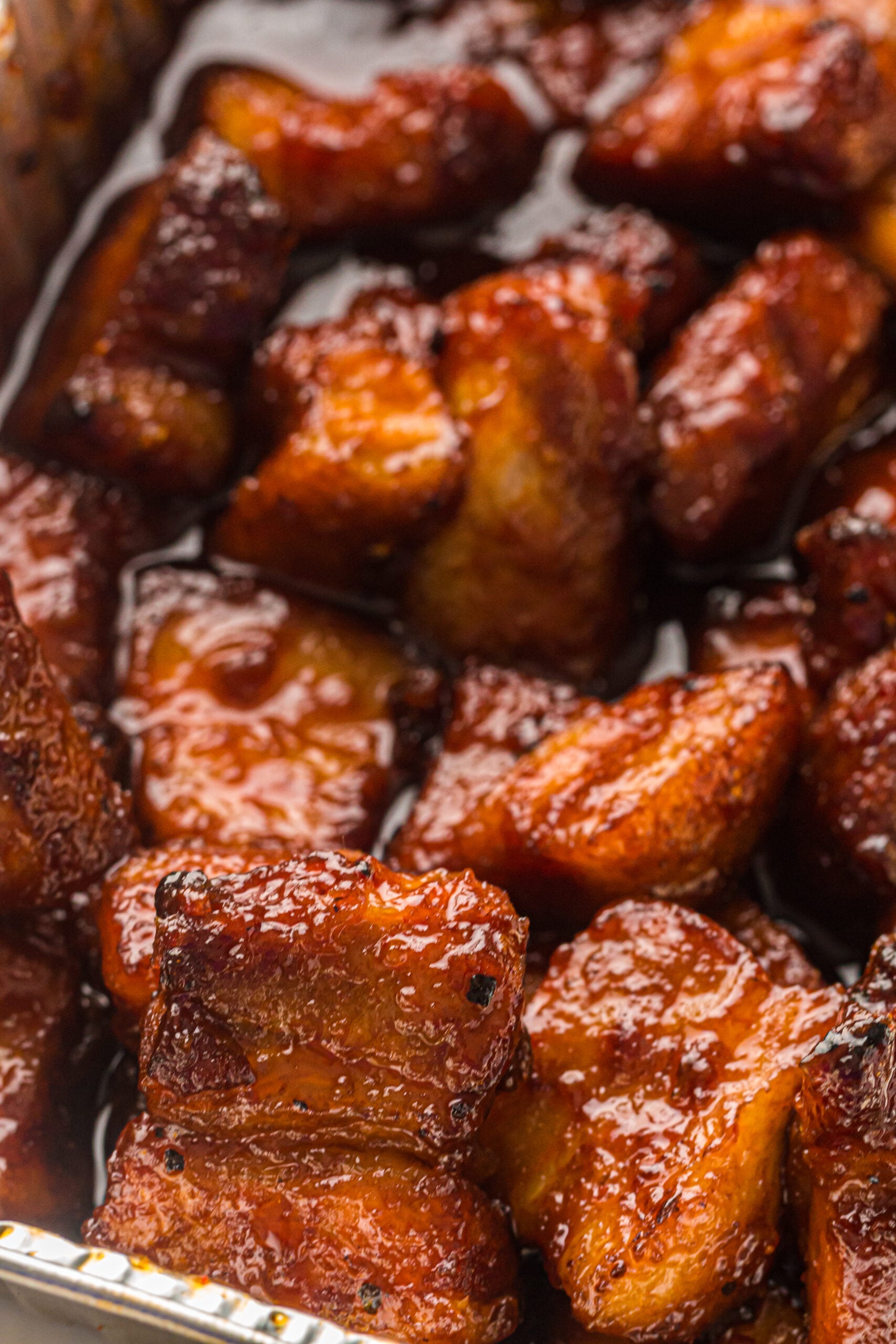 close up view of Smoked Pork Belly Burnt Ends piled on top of one another