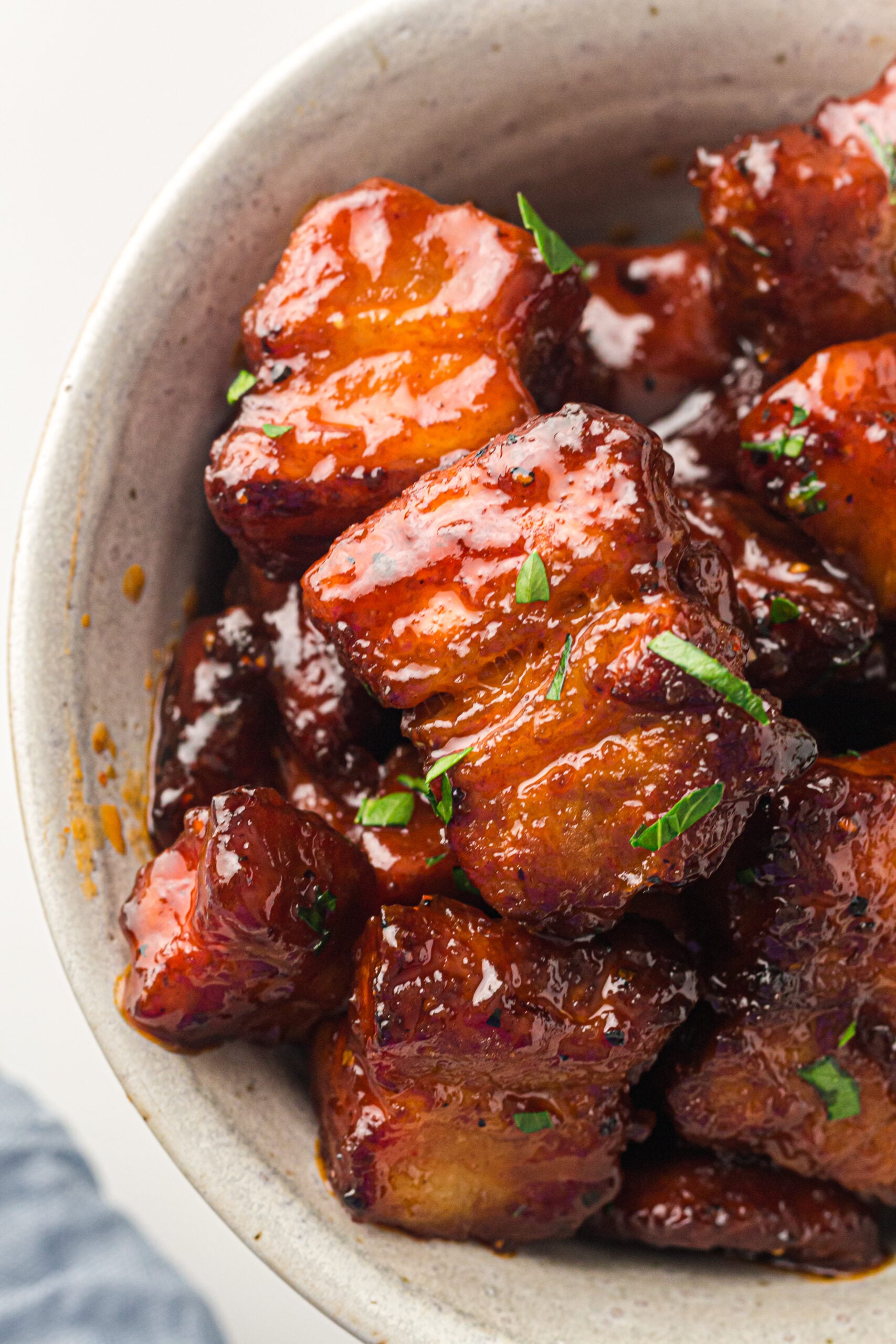 Smoked Pork Belly Burnt ends in a bowl up close showing texture