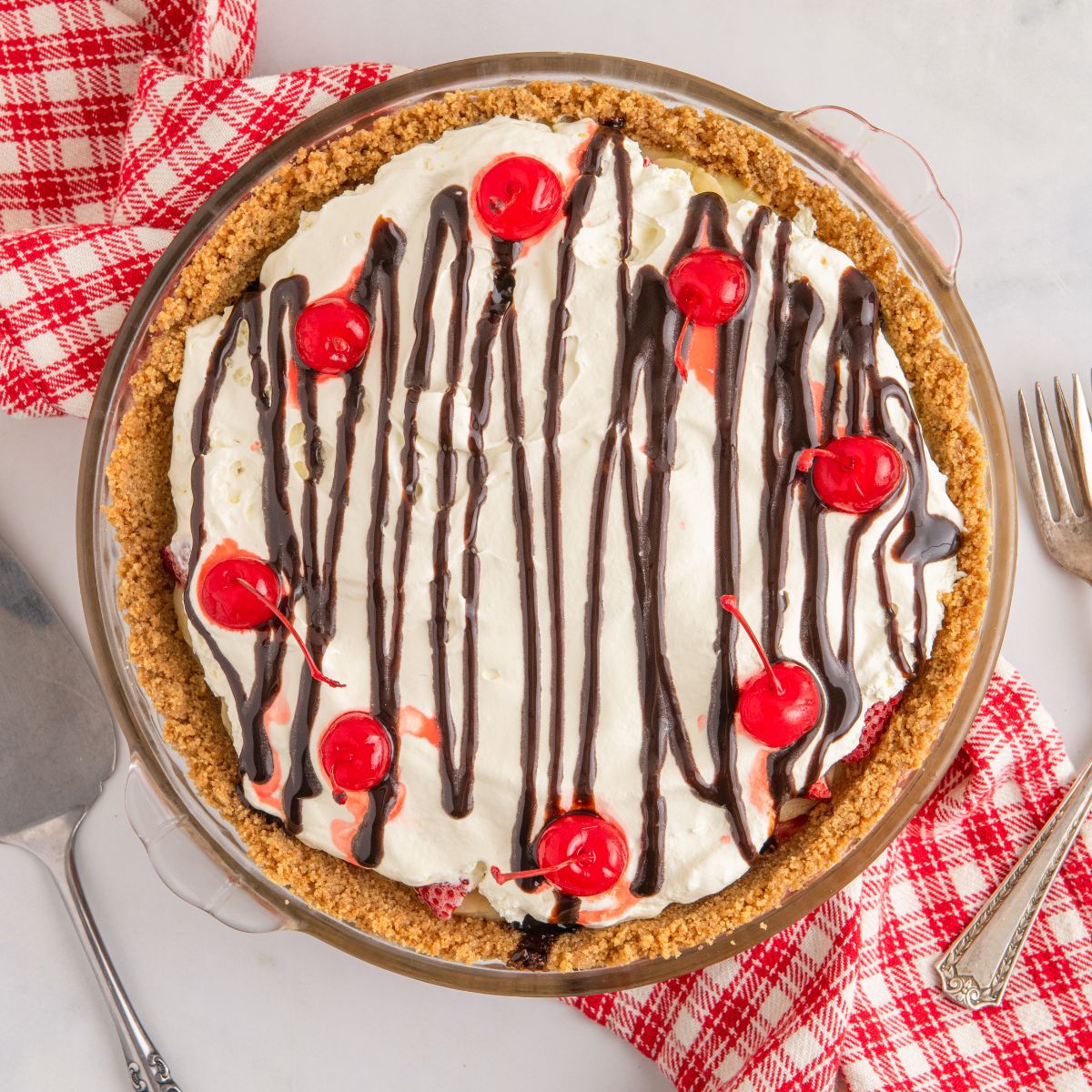 No Bake Banana Split Pie sitting on table with a napkin under it