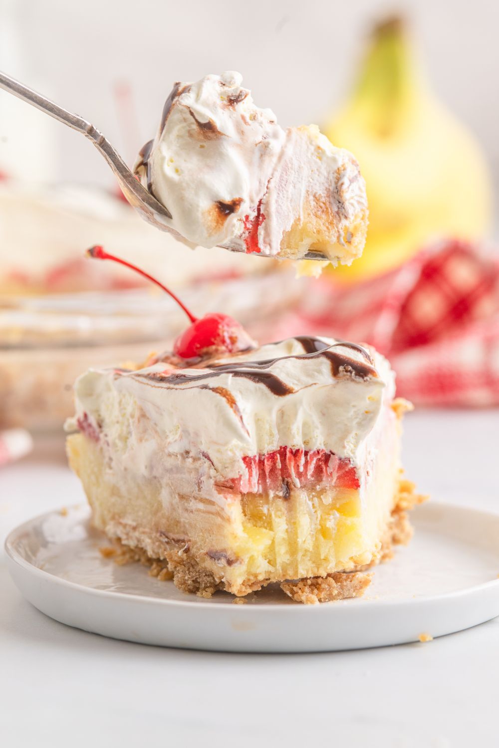 plate with a slice of No Bake Banana Split Pie on it with a bite taken out of it