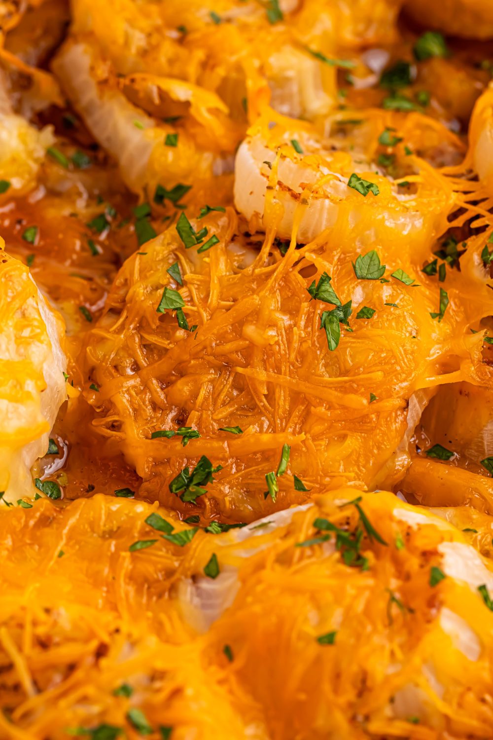 close up of Oven baked cheesy onions in pan