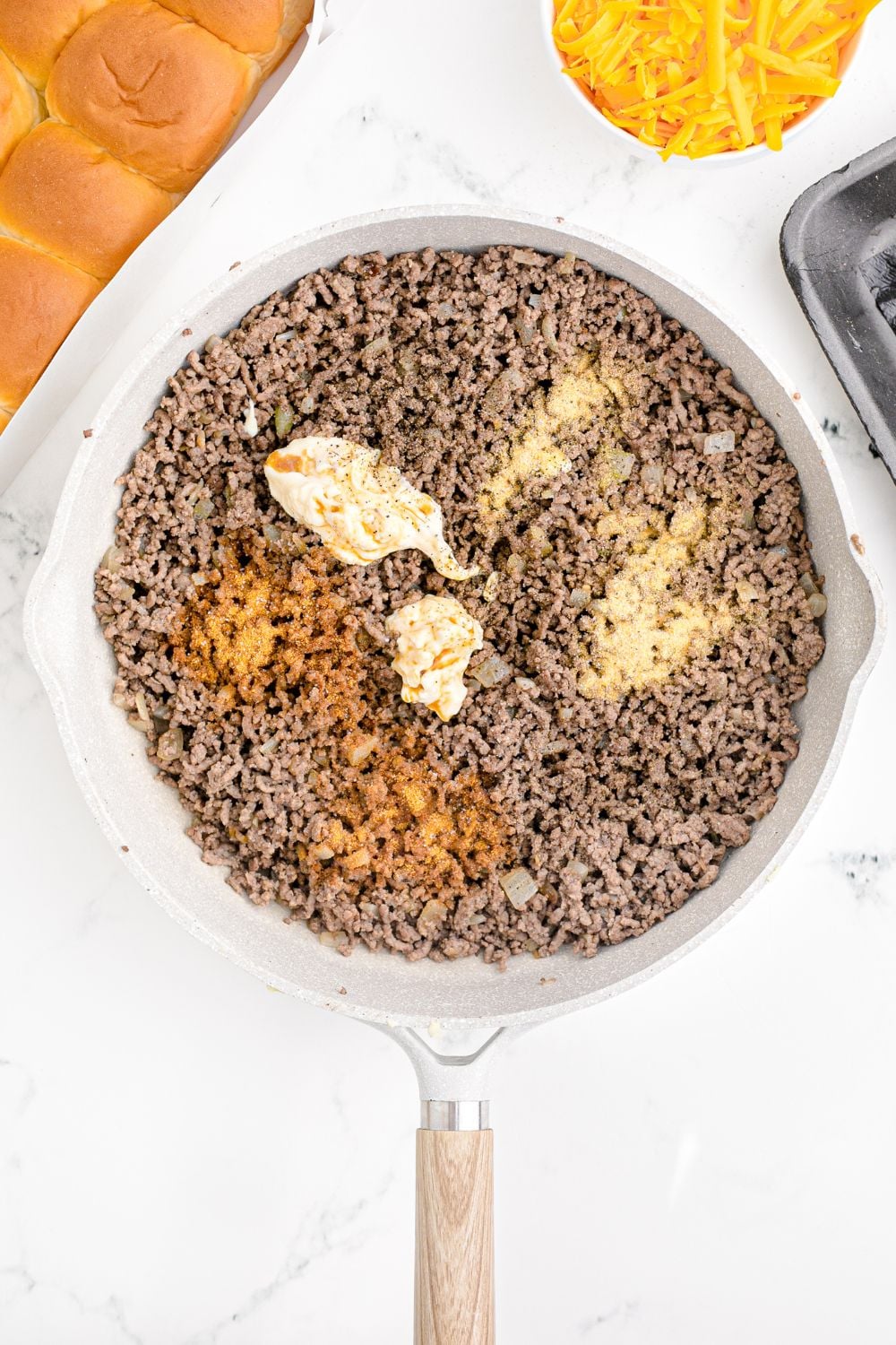 cooked ground beef with spices and seasonings on top of it