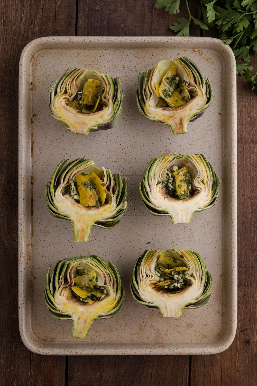 seasoned artichokes on baking tray