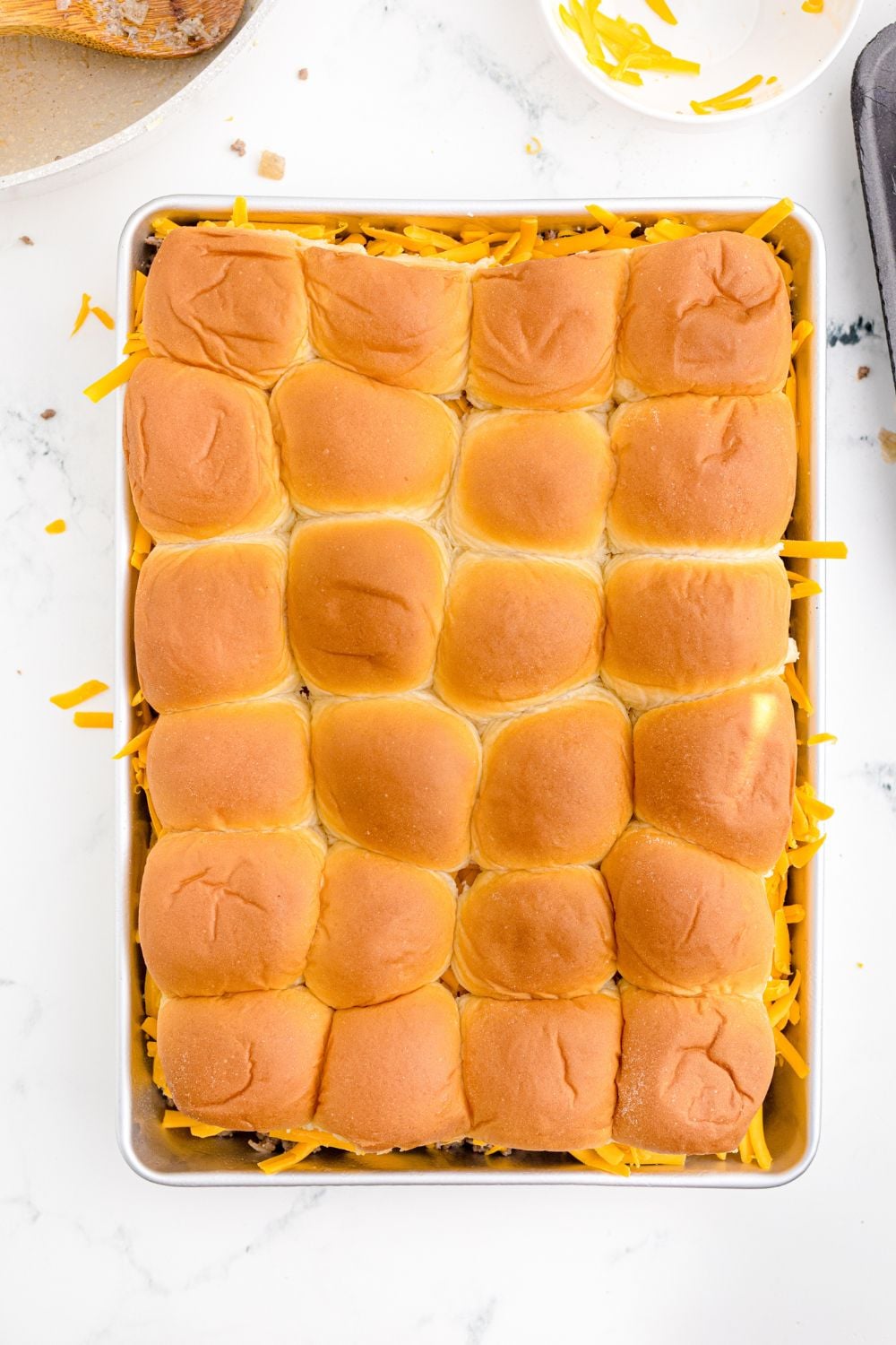 overhead view of Classic Cheeseburger Sliders in a casserole pan