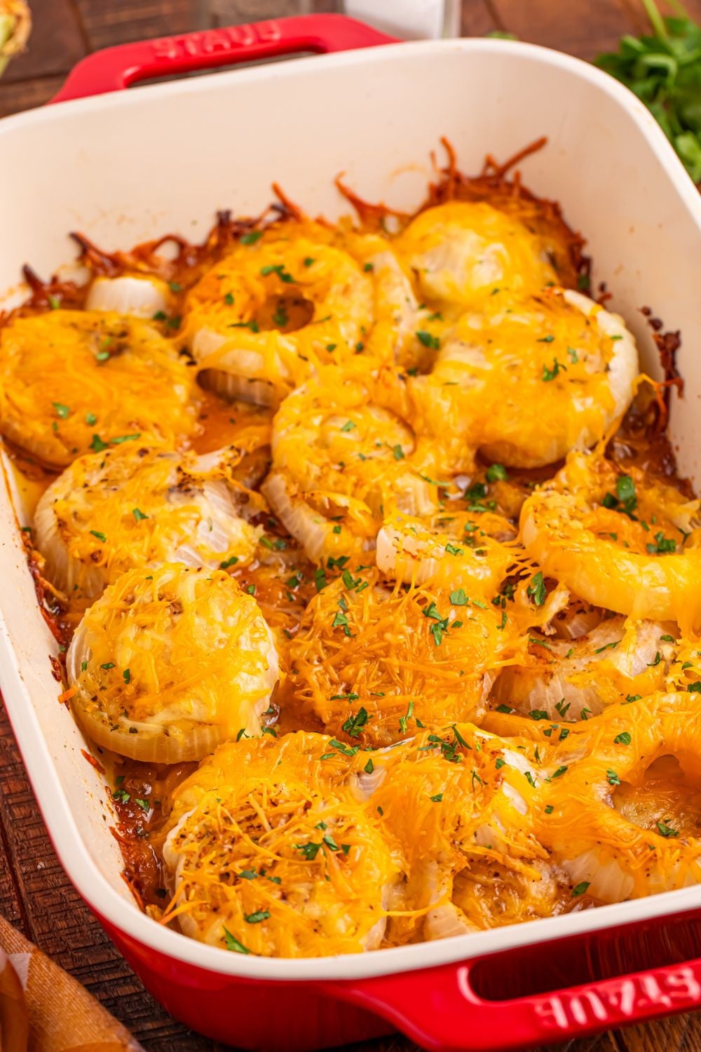 onion baked with cheese on top in a casserole dish