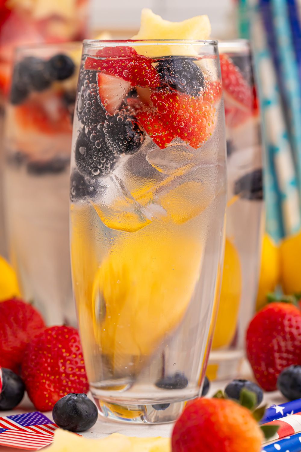 Patriotic Sparkling Lemonade in glasses with fruit scattered on table to add a pop of color 