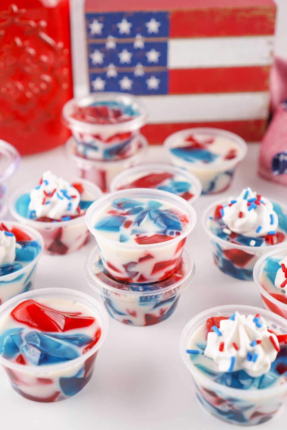Red White and Blue Jello Shots in containers stacked on table