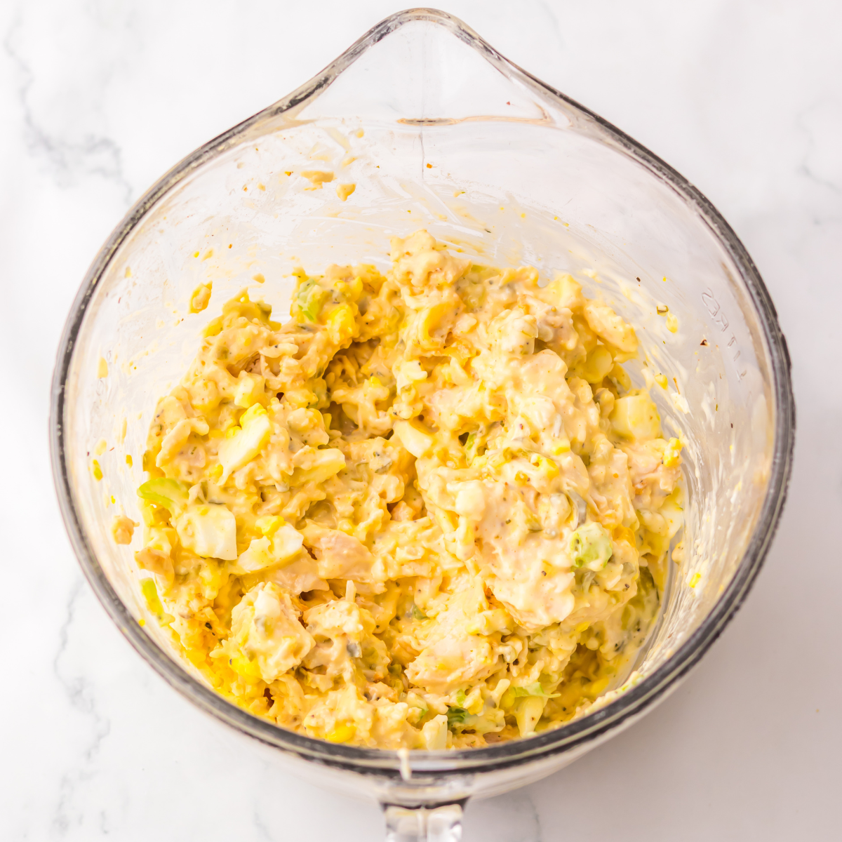 All of the ingredients mixed together in a large glass bowl. 