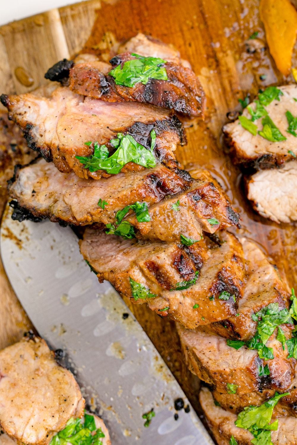 Grilled Pork Tenderloin sliced and then a knife set to the side 