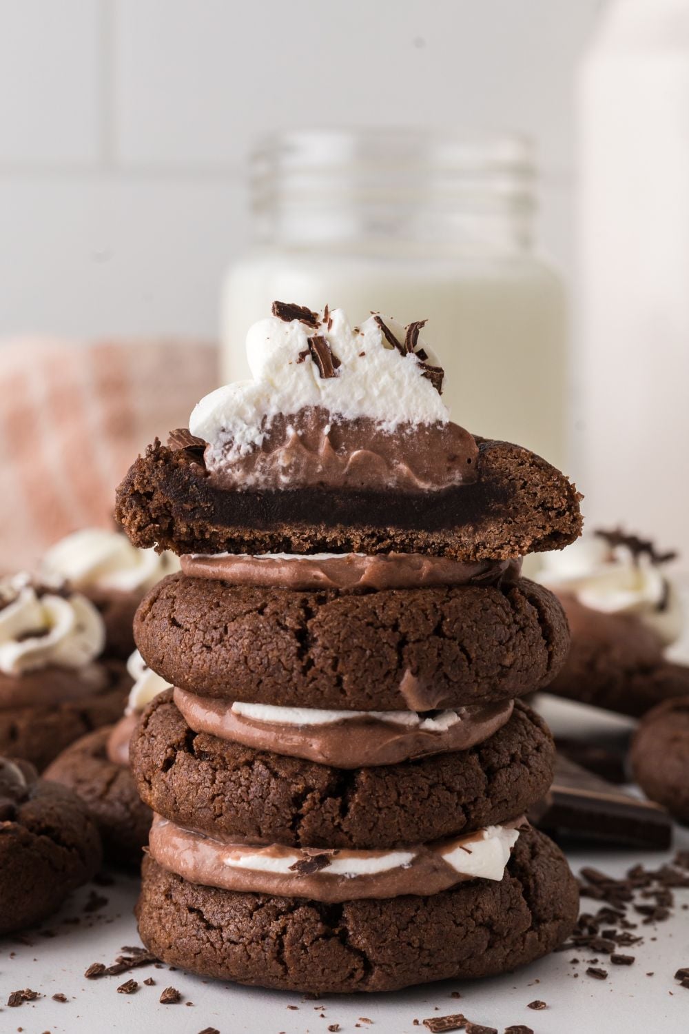 Chocolate Pie Cookies stacked on top of one another with one cut in half to see the layers