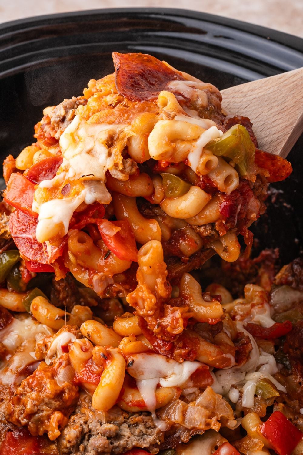 scoop of pizza casserole in slow cooker