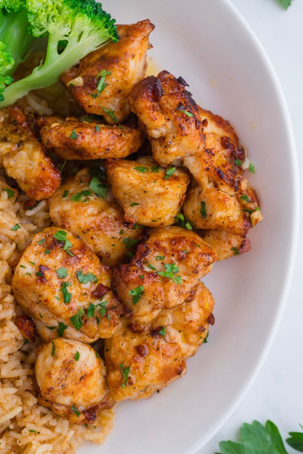 Garlic Butter Chicken Bites on plate with parsley on top