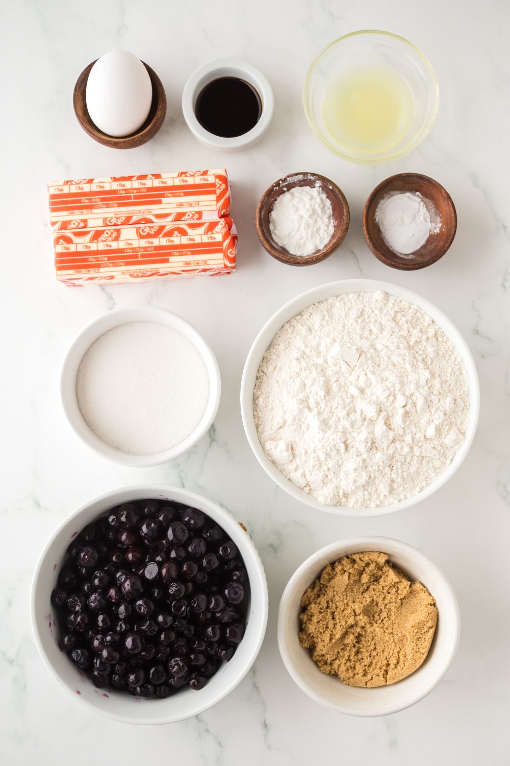 ingredients for Blueberry Crumb Bars in single serve containers on table
