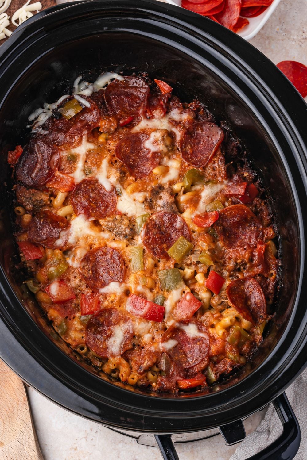 slow cooker on table with meaty pasta inside