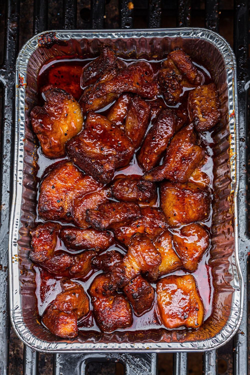 Smoked Pork Belly Burnt Ends in a pan on grill