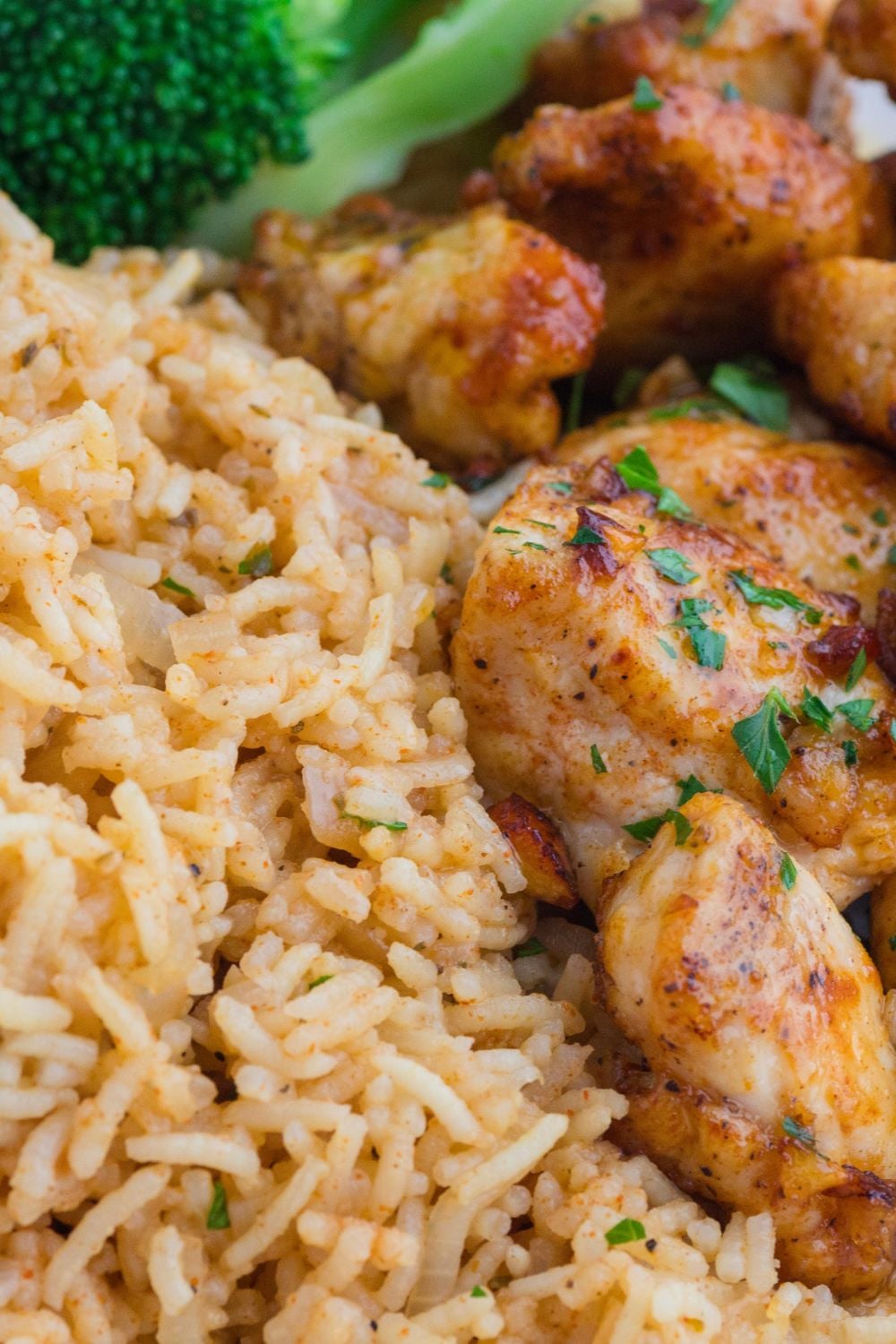 pile of rice on plate with chicken to the side of it