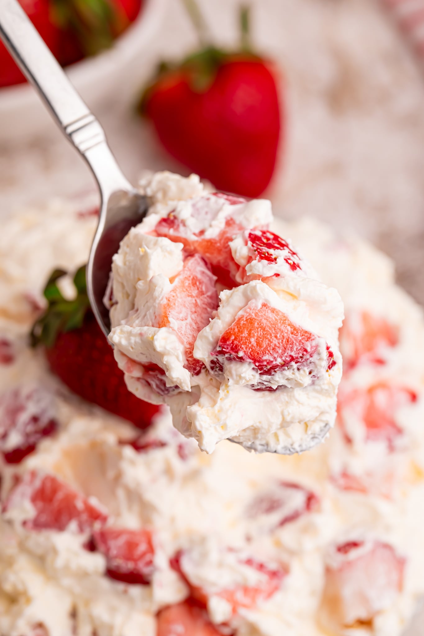 view of the strawberry cheesecake salad bite on a spoon