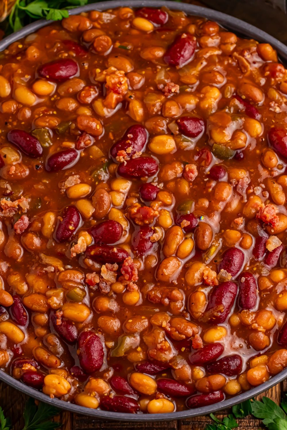 Crockpot bourbon baked beans in a black bowl sitting on table