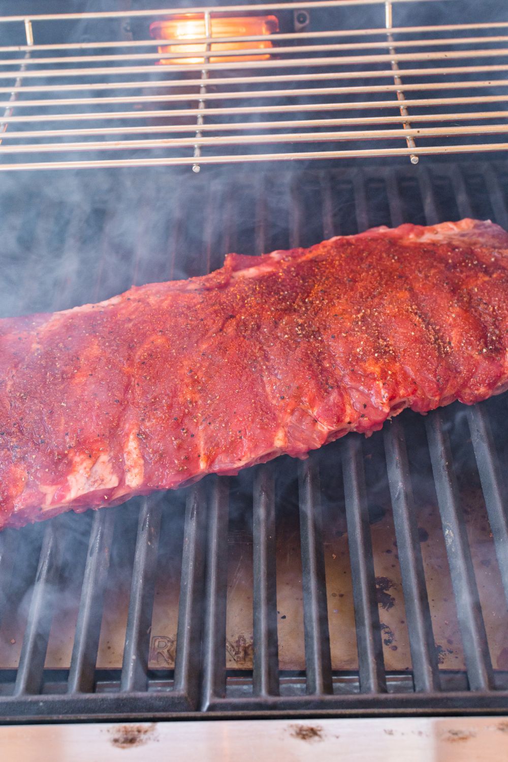 raw BBQ Baby Back Ribs on a grill