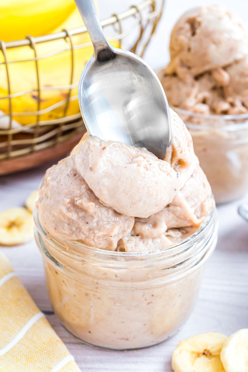 glass bowl with Banana Ice Cream in it and a spoon poking inside