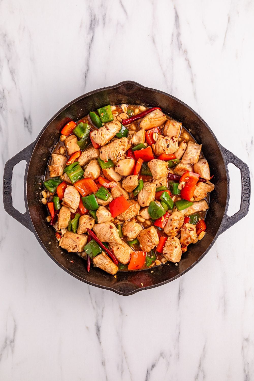Better Than Takeout Kung Pao Chicken in a cast iron skillet on table