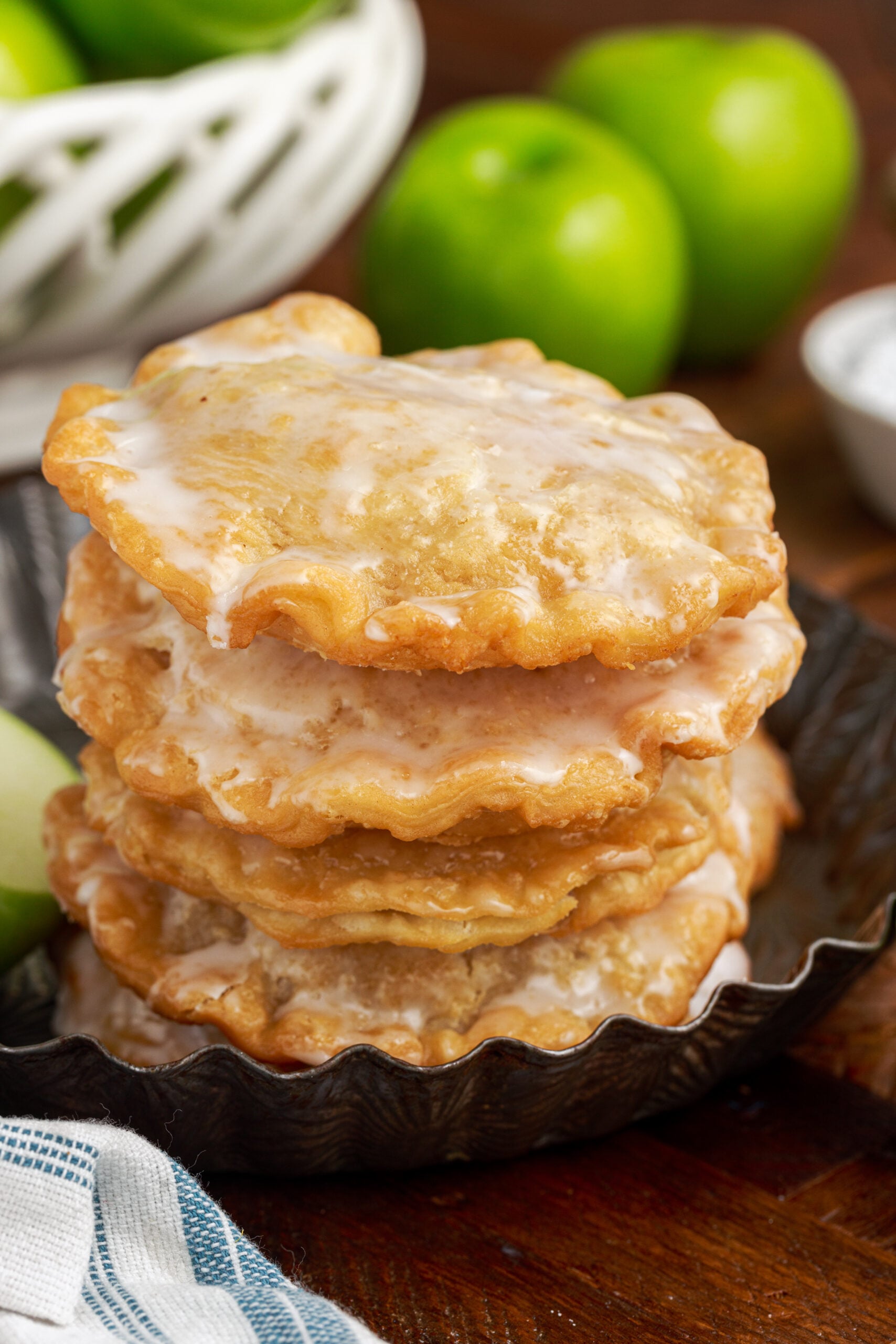 stack of Deep Fried Apple Hand Pies on top of each other drizzled with glaze