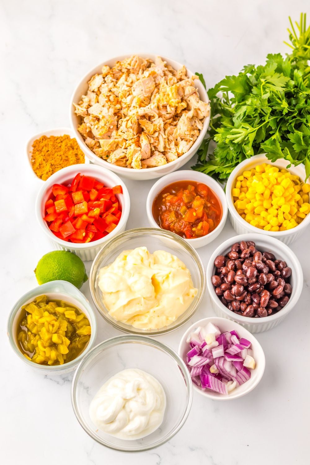 ingredients for Creamy Taco Chicken Salad in single serve bowls sitting on table